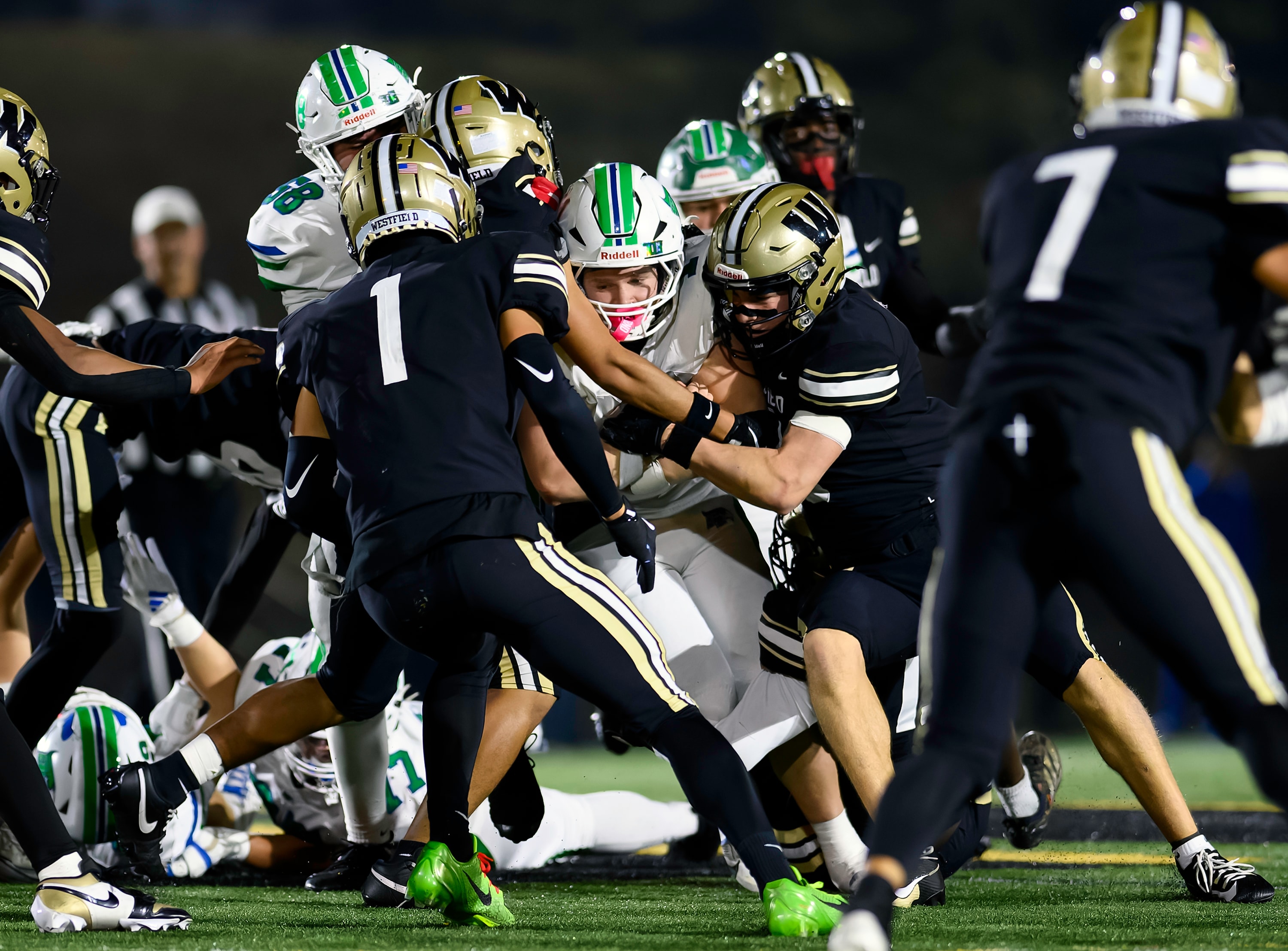 Football tackle in a pile of players